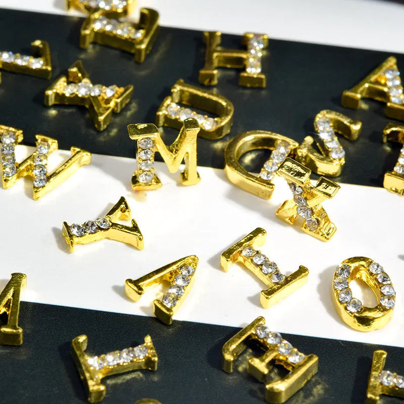 Gold alloy letter A nail ornament charm with crystal detail on a square chain base