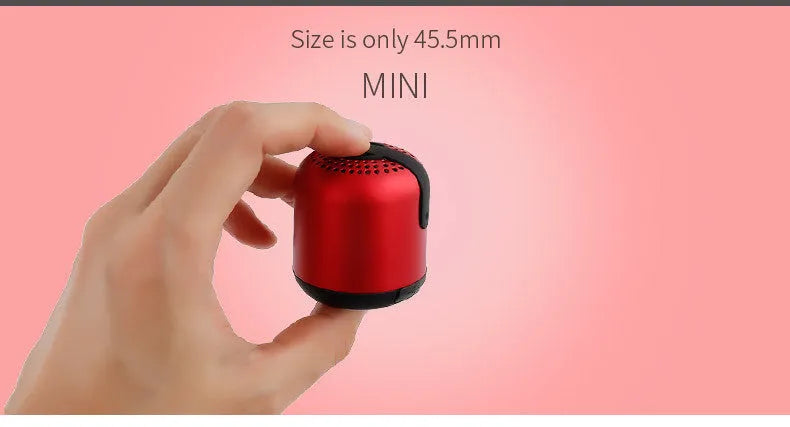 Hieha XQ11 cylinder-shaped mini portable Bluetooth speaker in metallic colour on a table.