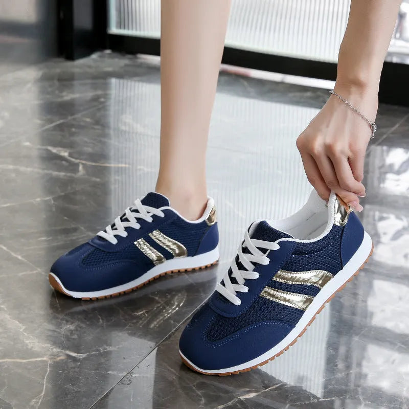 Blue women's casual sports shoes with cross shoulder straps and white rubber sole, shown on a size label.