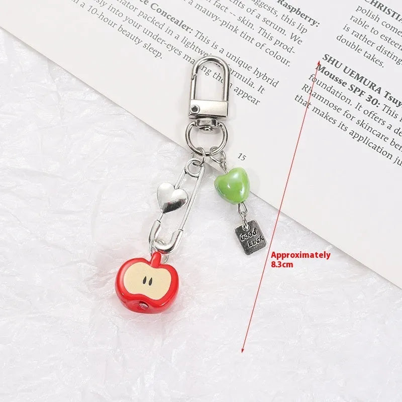 Plastic resin fruit phone charm keychain with strawberry design on white rope cord