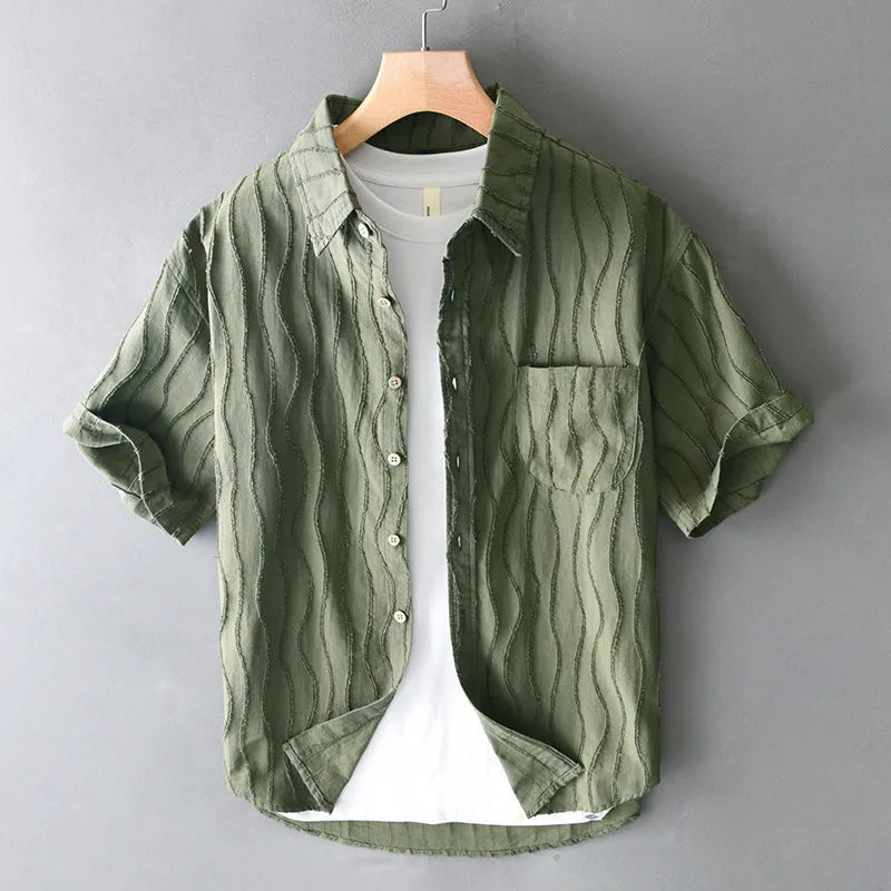 Man wearing a loose fit apricot coloured pure cotton short sleeve casual shirt