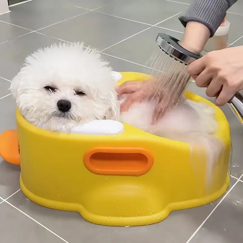 Blue PVC duck-shaped pet bath tub for washing dogs and cats on a bathroom floor.