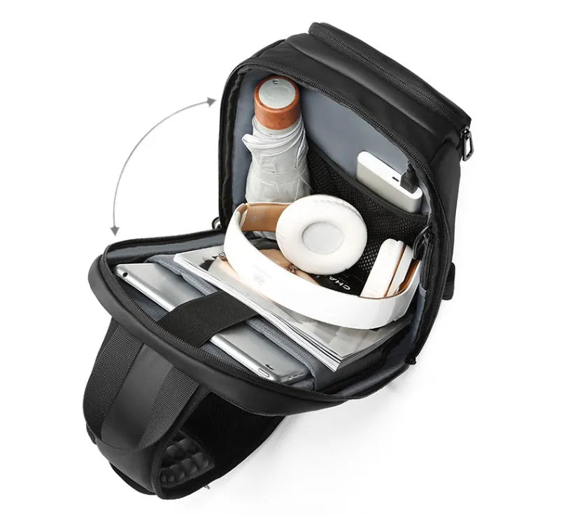 Black PVC outdoor shoulder bag showing medium size, shoulder strap, and internal pocket organisation