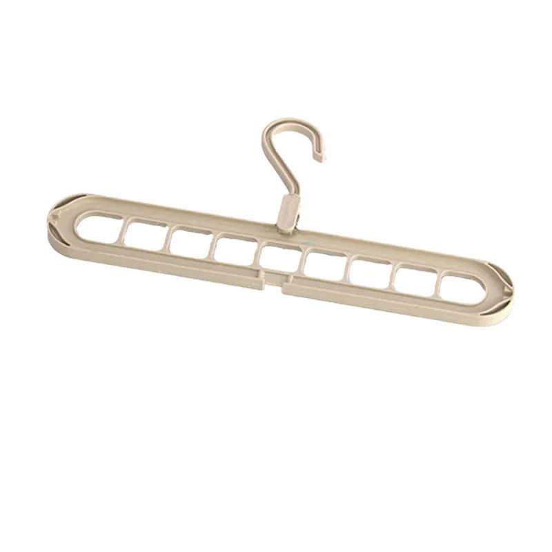 Green plastic nine-hole folding hanger for trousers displayed open and folded flat.