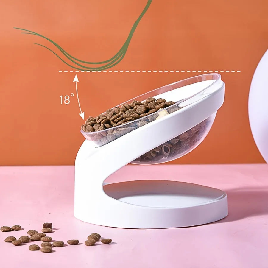 White clear plastic elevated cat food bowl with tilted anti-vomit design on a raised stand.