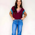 Burgundy women's V-neck loose sweater with contrast trim and short cuffed sleeves