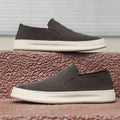 Men's grey slip-on casual shoes with round toe design and visible stitching details