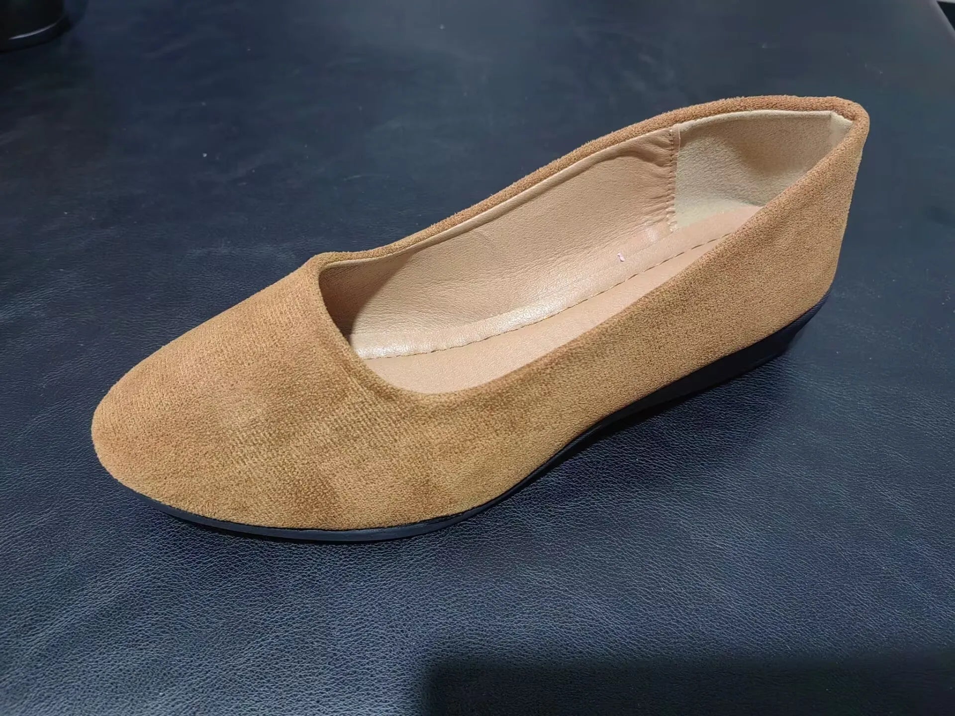 Women's suede wedge pump shoes in light brown with a low rubber sole and rounded toe.