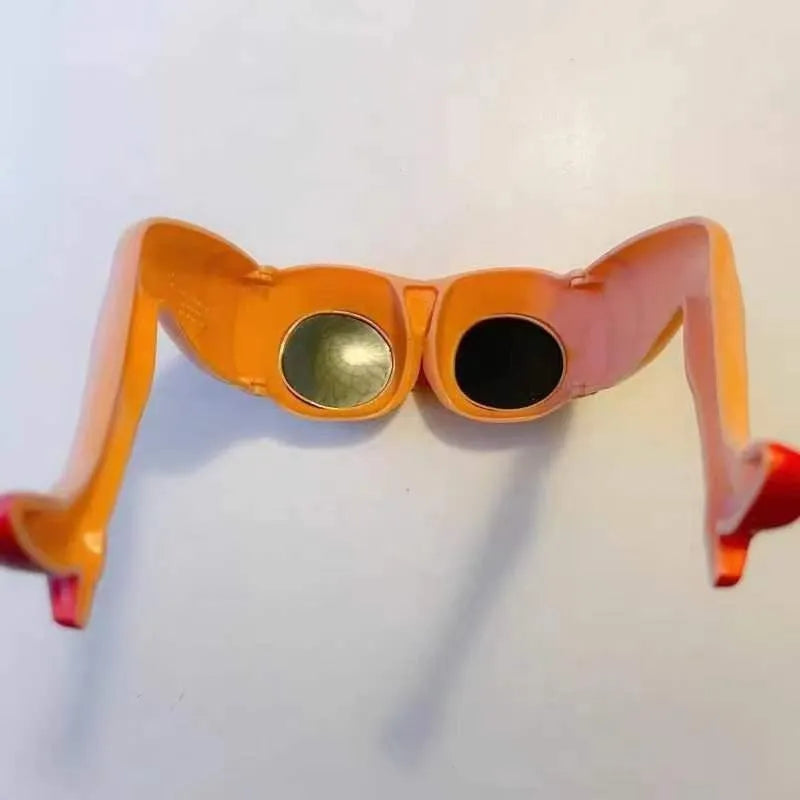 Orange plastic novelty sunglasses with a distinctive leg hip design on the frame.