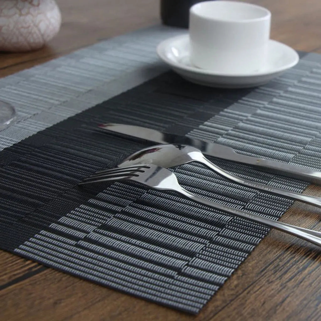 PVC non-slip dish mat in modern simple style on a dining table, showing gradient bamboo black colour option.