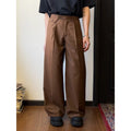 Men's straight-leg casual trousers in black with wide-leg draping silhouette on hanger