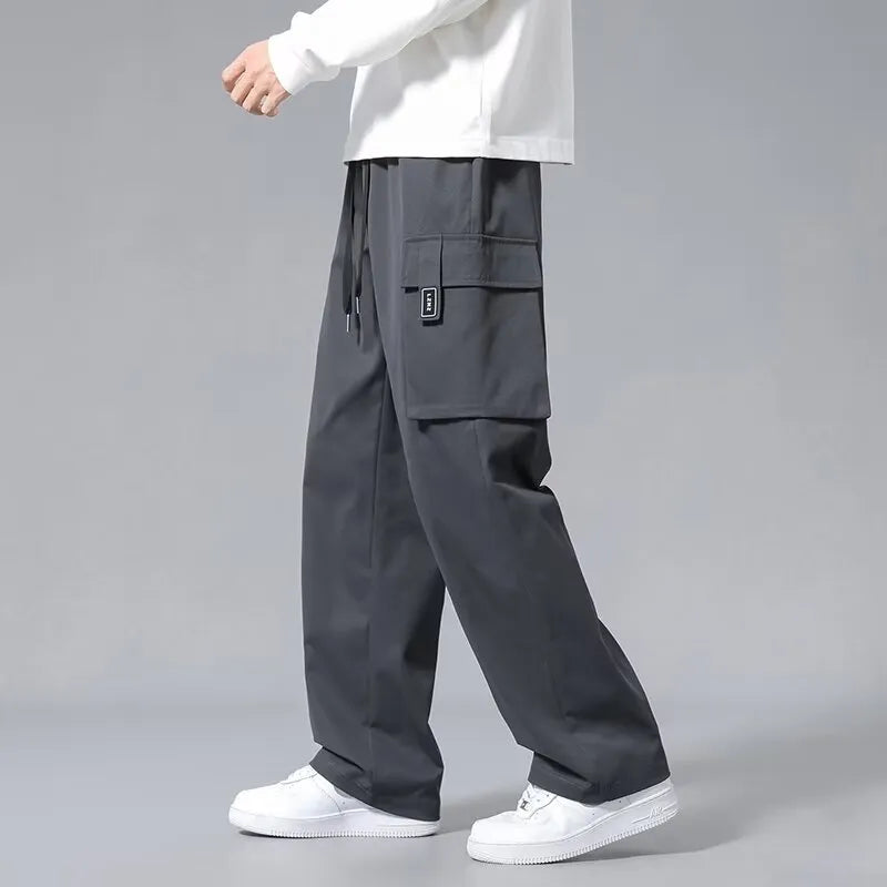 Boys' straight-leg cargo pants in army green with drawstring waist and multiple large pockets.