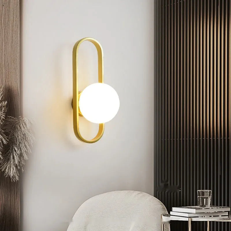 Minimalist wall lamp with glass shade and iron body in black or gold finish showing three light mode options