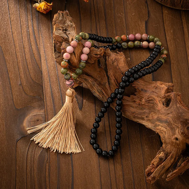 Vintage bohemian long necklace with geometric stone beads and tassel, shown with a matching shorter bracelet.