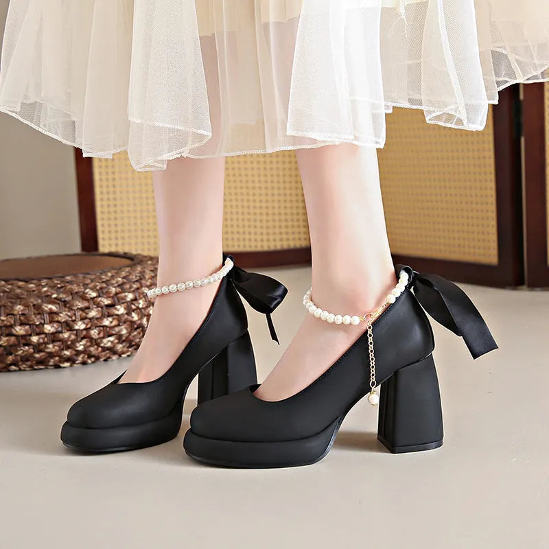 Women's beige Mary Jane shoes with a chunky heel, round toe, and a buckle fastening on the ankle strap.