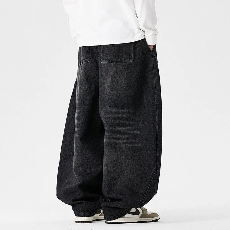 Men's plus size baggy jeans in dark blue denim with a straight leg and low waist.