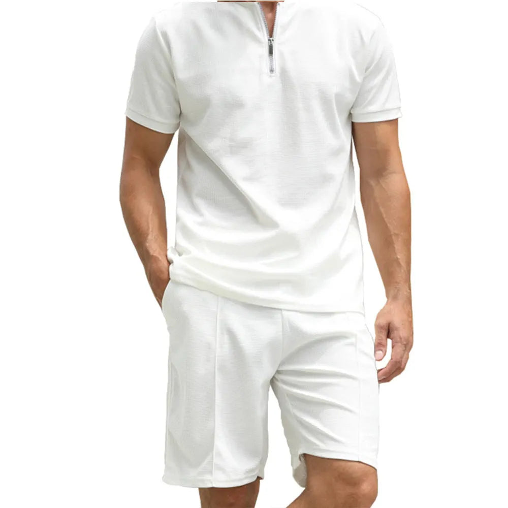 Man wearing a solid colour polo shirt and matching trousers from a two-piece set in beaded bird's eye polyester fabric.