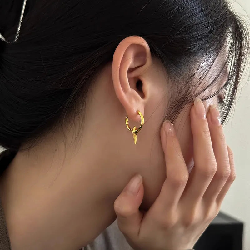 A pair of gold and white electroplated geometric star ear clips made from solid copper for women.