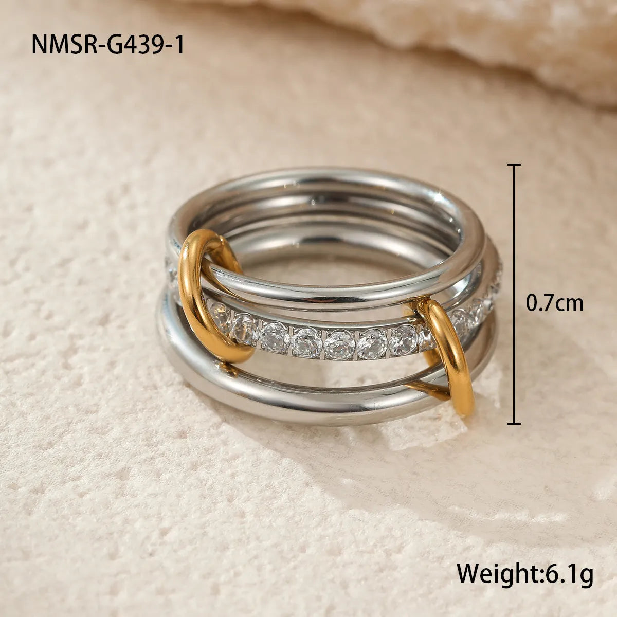 Stacked gold plated stainless steel rings showing layered jewellery look on female hand