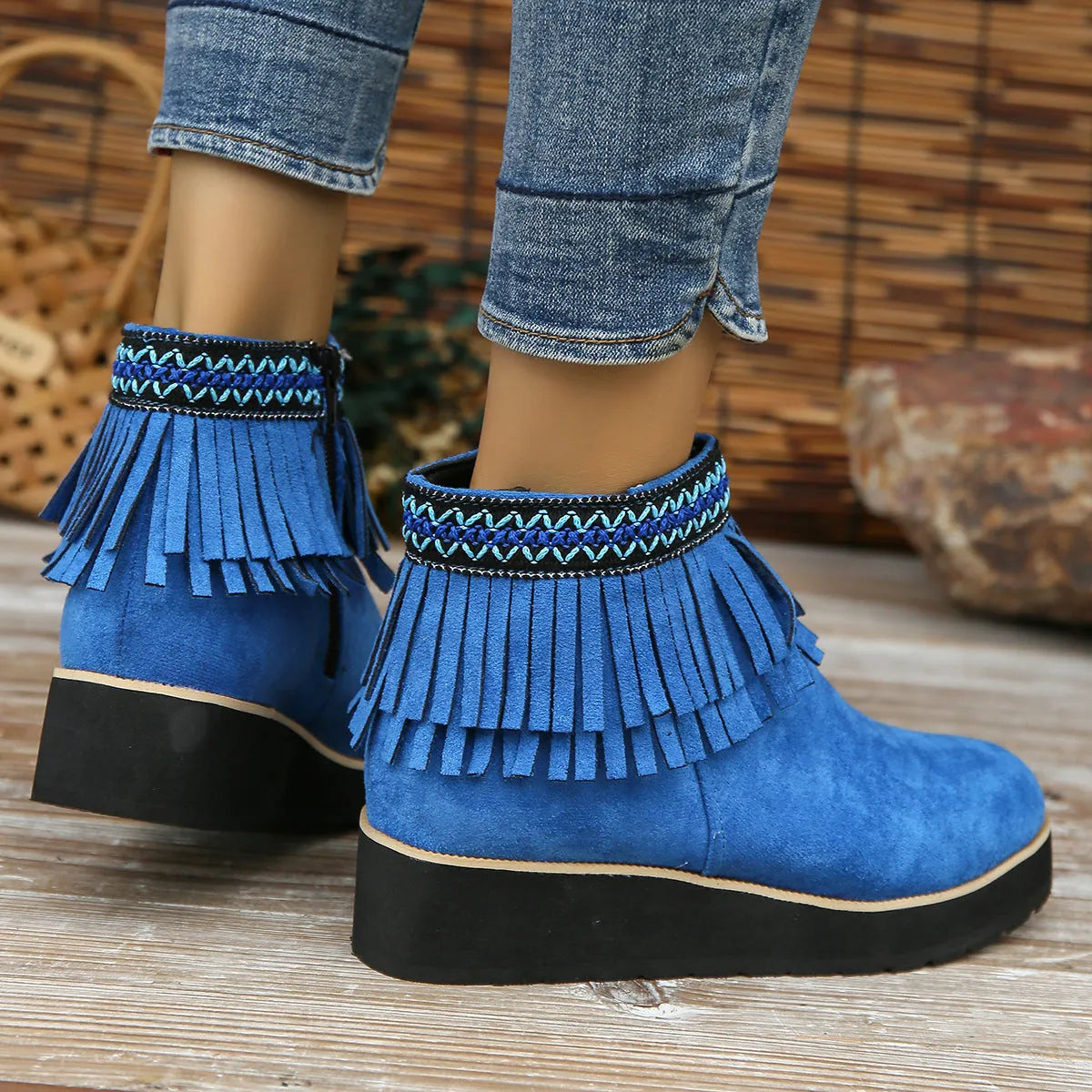 Women's dark brown suede wedge bootie with side zip, tassel detail, and thick rubber sole