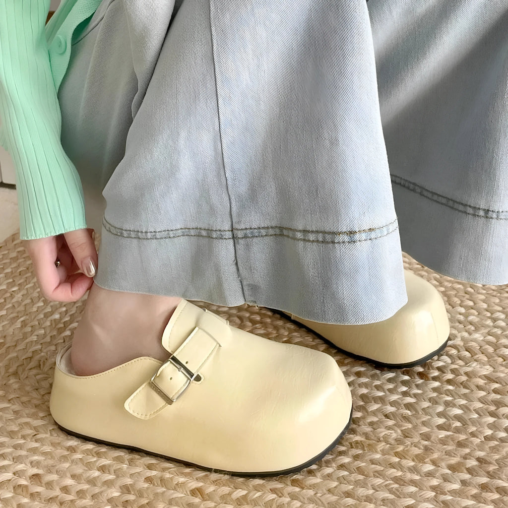 Women's flat buckle casual sneakers in yellow, creamy-white, silver, and black colours with round toe design
