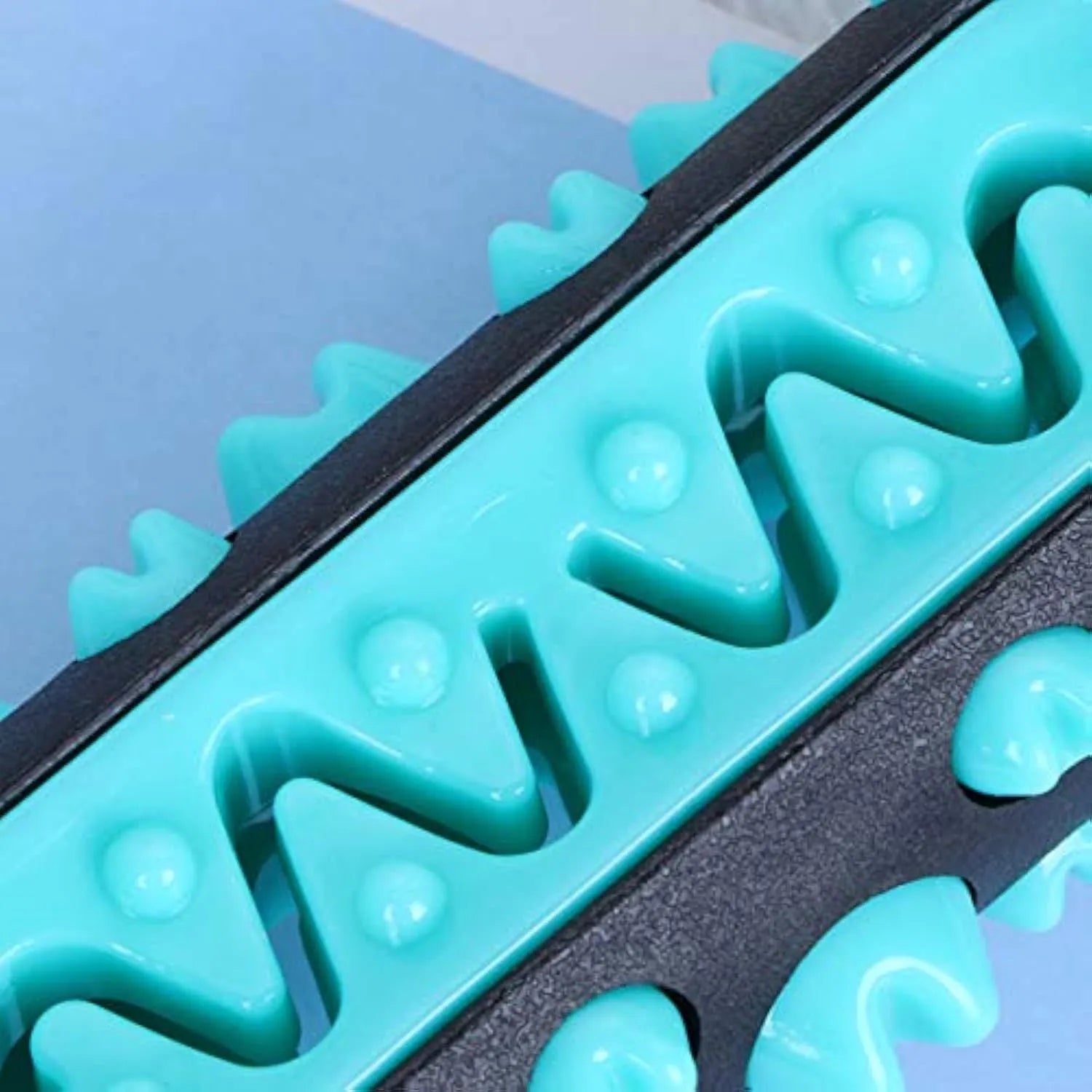A 15cm long natural rubber dog toothbrush chew toy in assorted colours.