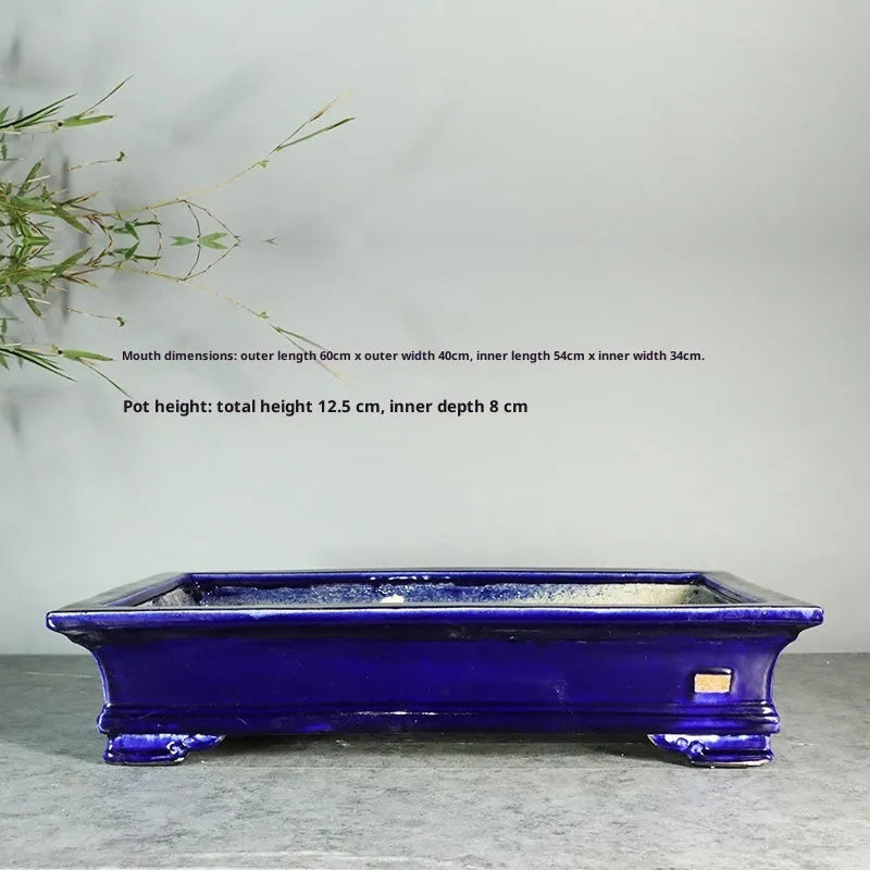 White cracked ceramic bonsai flowerpot with bamboo plant, manual purple sand craft