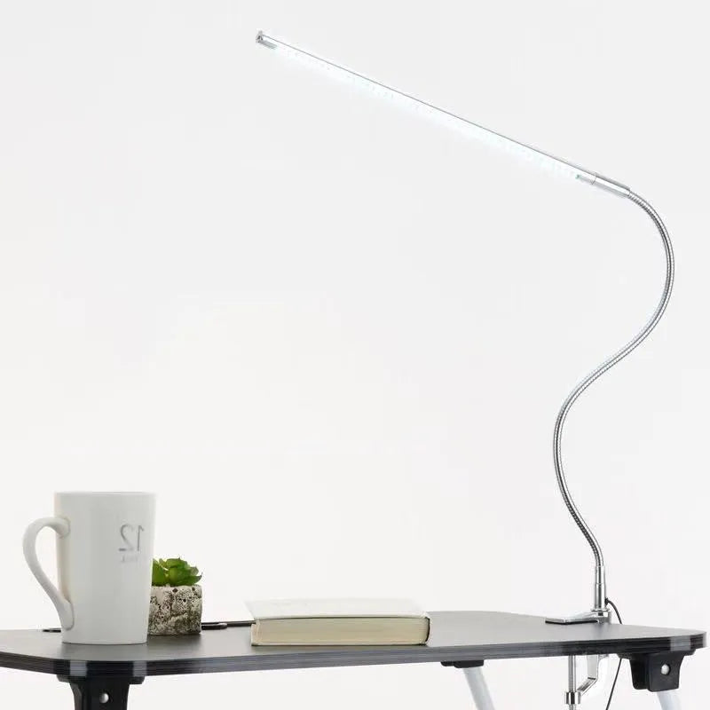 Silver USB-powered LED clip-on table lamp with long arm extended, showing the lamp head and clip mount.