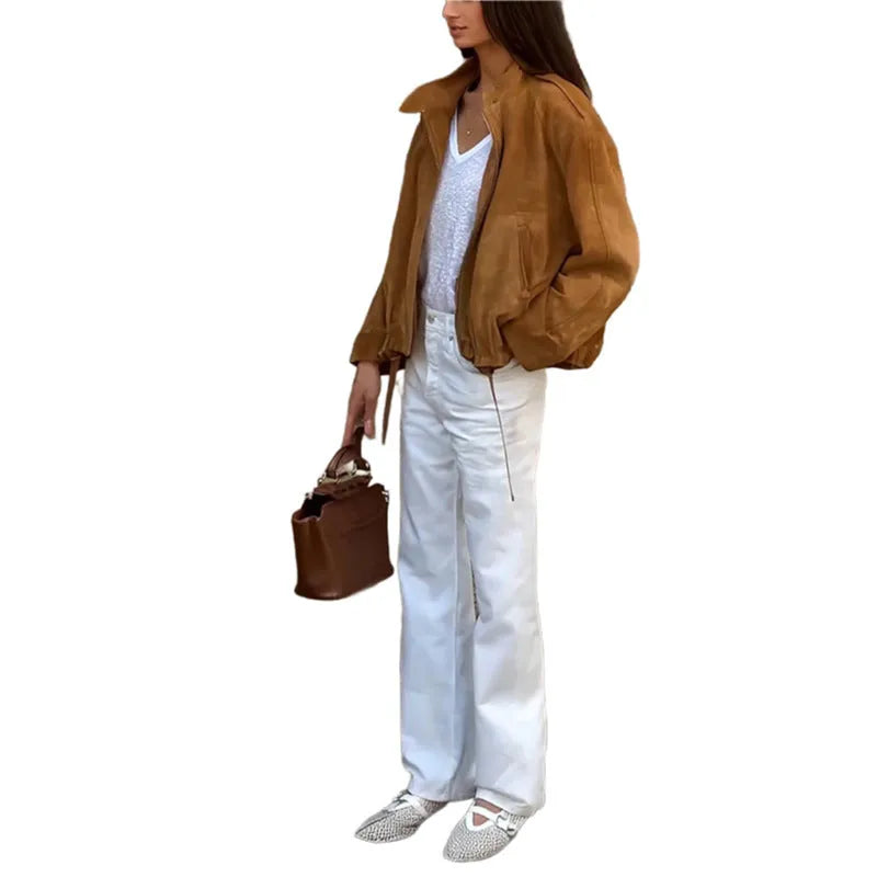 Man wearing a solid colour loose fit retro-style long sleeve polyester jacket.