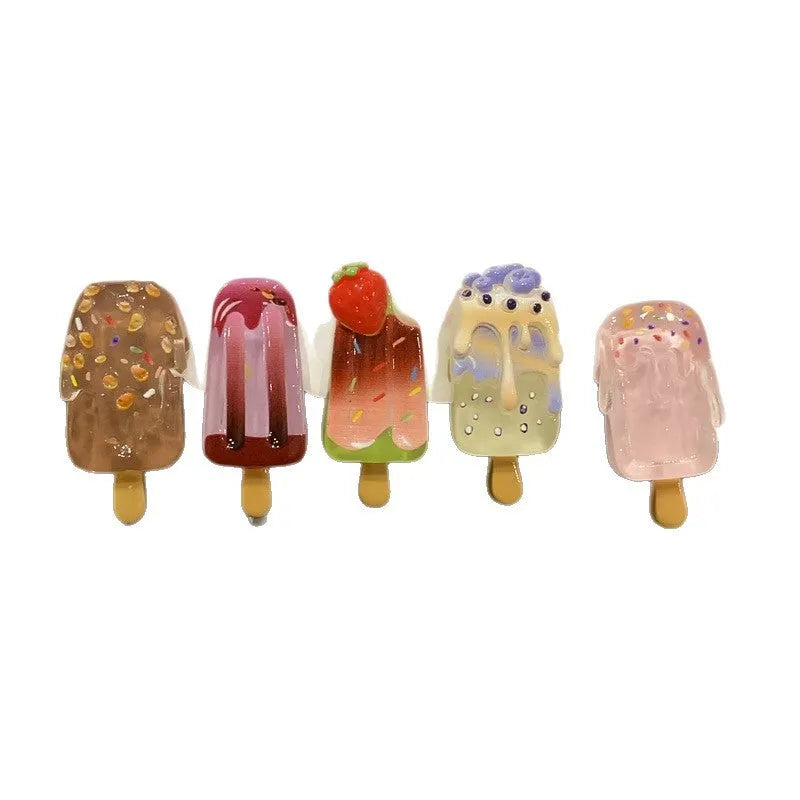 Close-up of a handmade resin hair barrette with a cute cartoon ice cream design in a choice of colours.