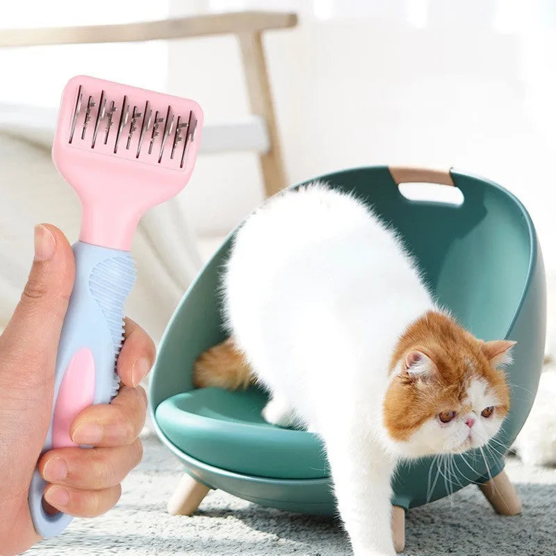 Pink stainless steel dog grooming comb with knot knife and massage pins on a white background.