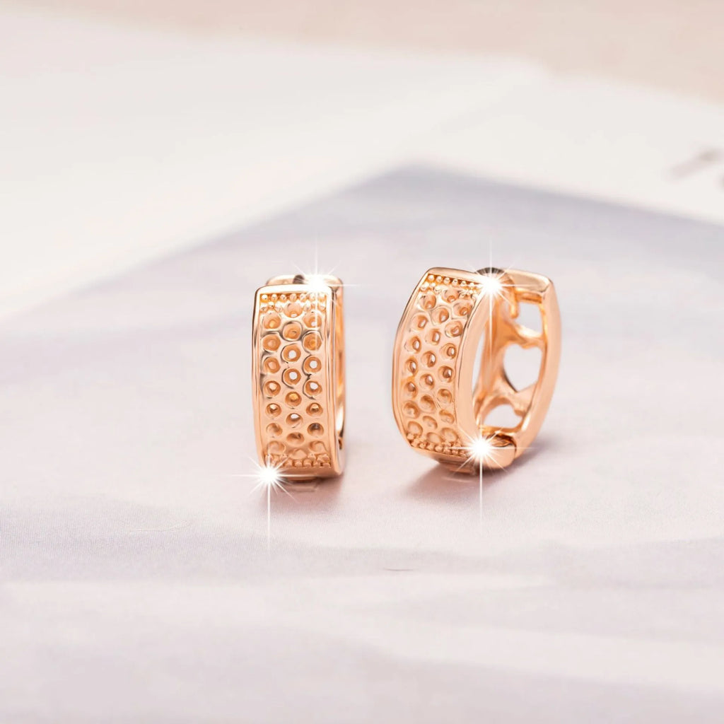 Rose gold women's earrings with hollowed out heart design in circular frame