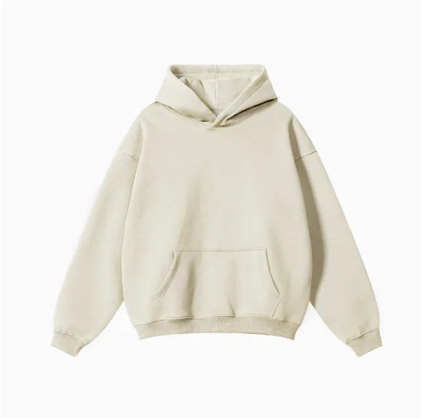 Man wearing a loose-fit grey terry cotton hooded sweater with drop-shoulder sleeves.