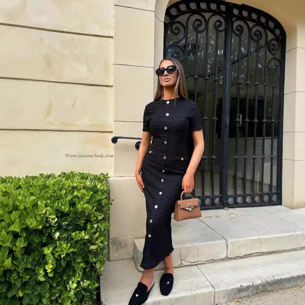 French retro slim fit knitted long sleeve dress in black, showing button detail and one-step skirt.
