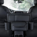 Black leather car interseat storage bag holding a tissue box, hanging between vehicle front seats.