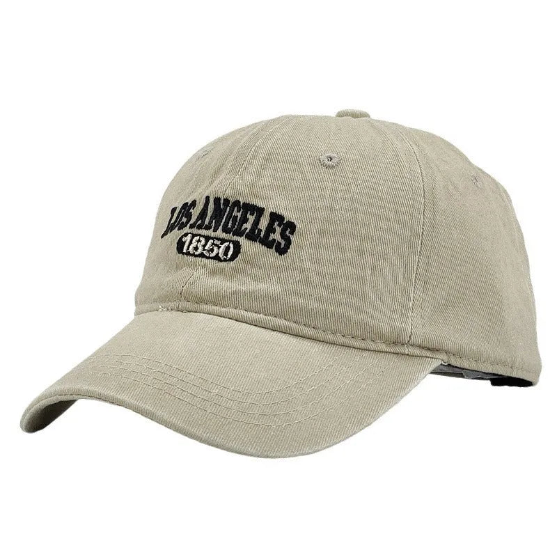 Retro-style personalised baseball cap with distressed letter embroidery on an adjustable strap, shown in beige colour.