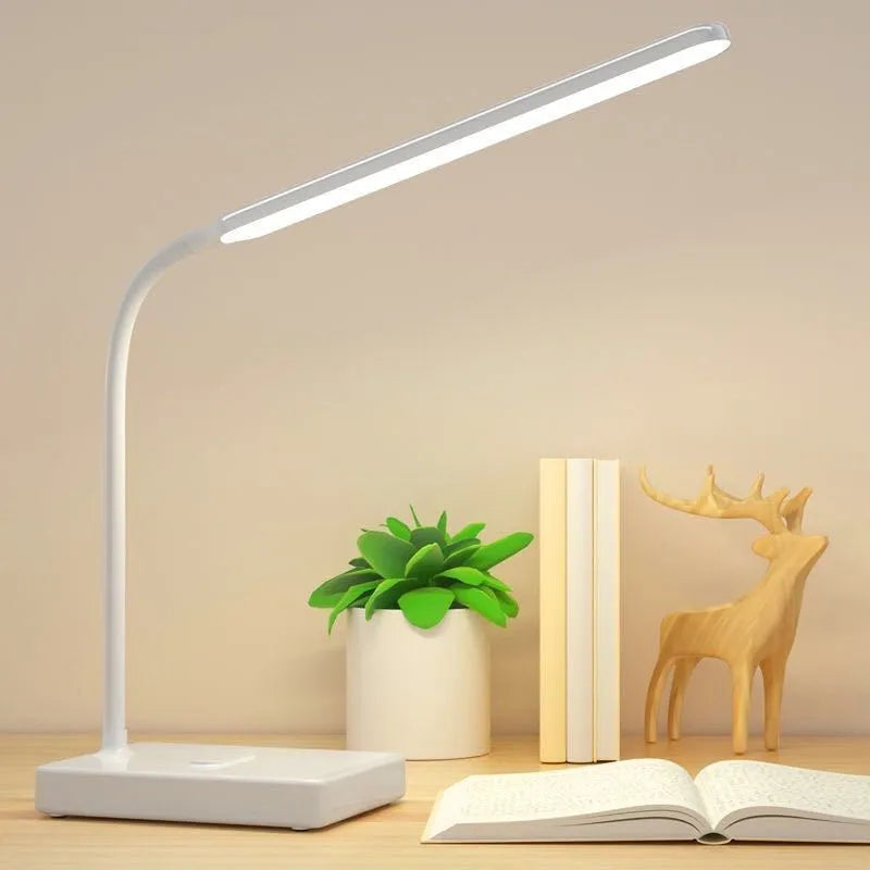 White USB charging folding LED desk lamp with touch switch and lithium battery on a desk
