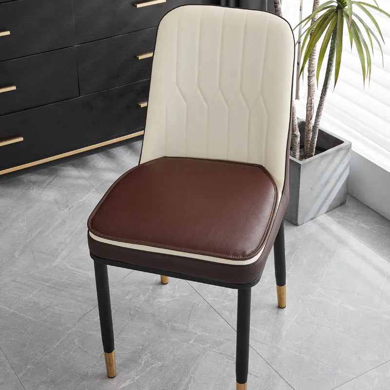 Leather horseshoe-shaped seat cushion in beige colour on a wooden chair, showing non-slip base