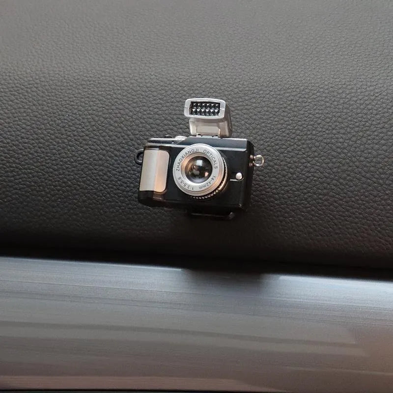 Pack of four retro camera dot design adhesive hooks for car interiors.