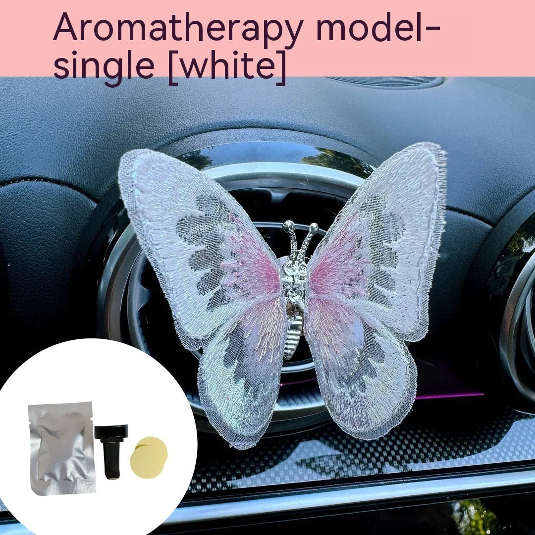 Moving embroidery butterfly decoration on car centre console air vent in pink fabric