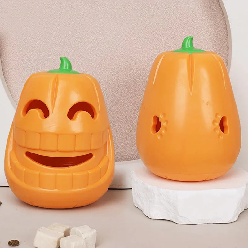 Orange Halloween pumpkin shaped rubber dog toy with a central treat-dispensing funnel.