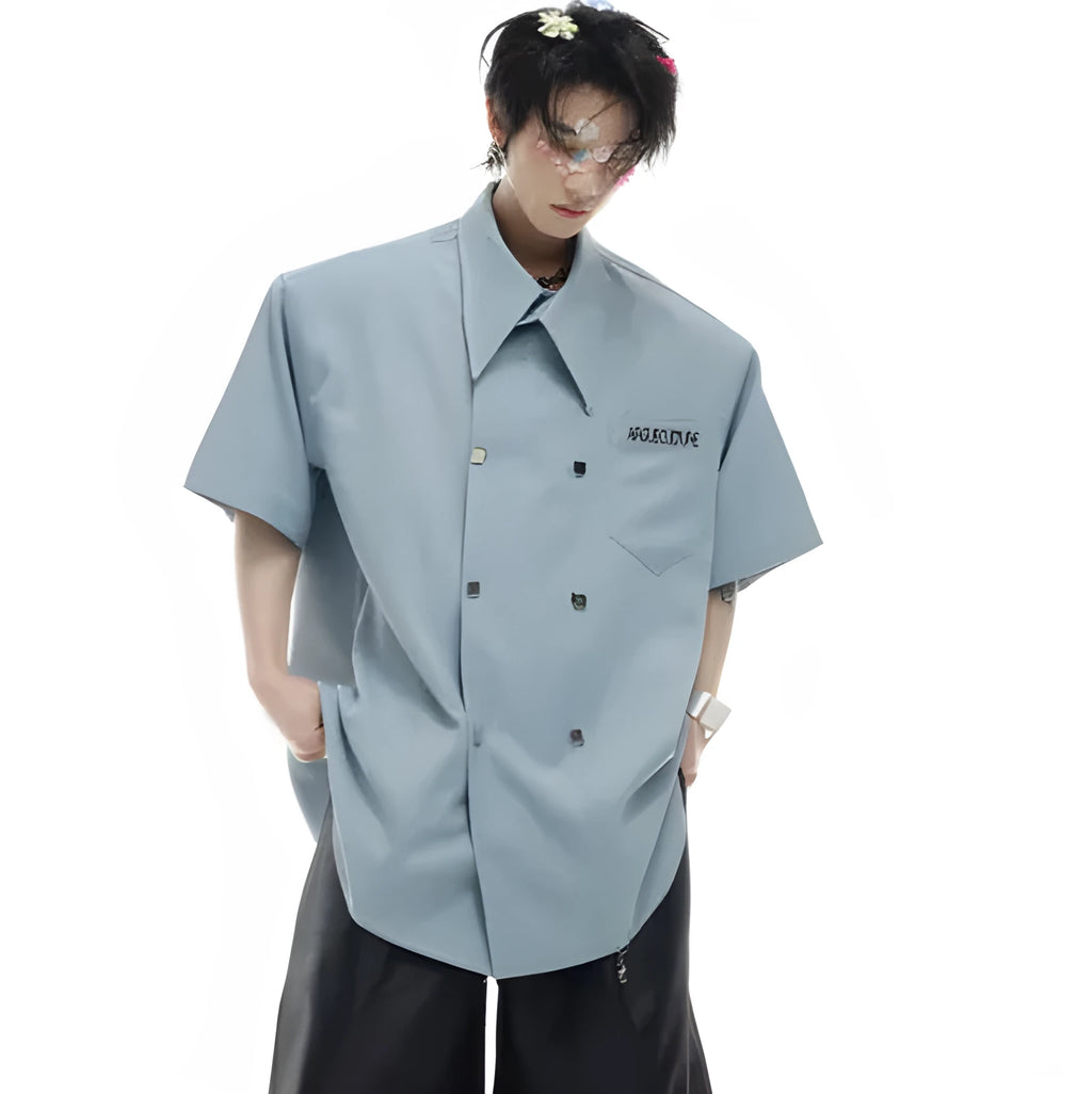 A man's loose-fit casual short-sleeved shirt in a blue colour with a lapel collar and decorative splicing details.