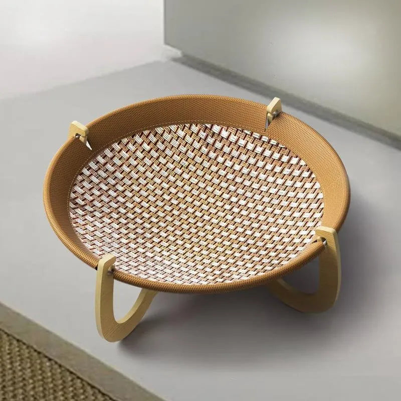 Brown square woven rattan raised hammock bed for cats and dogs on a wooden floor.