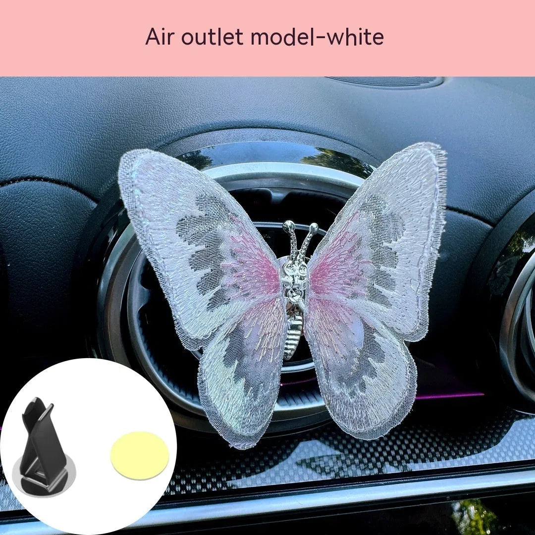 Moving embroidery butterfly decoration on car centre console air vent in pink fabric