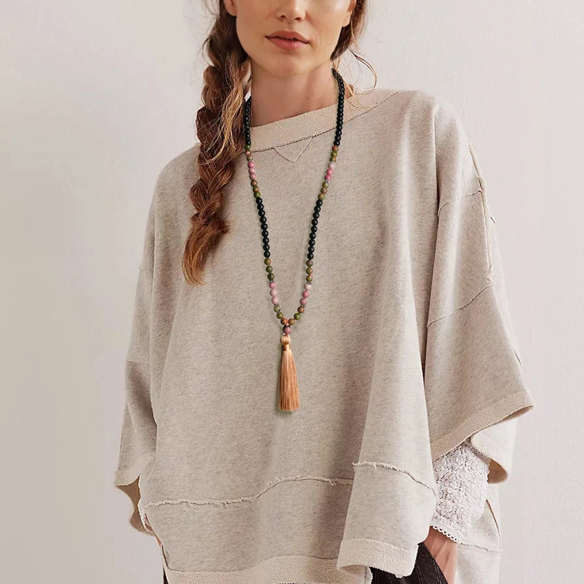 Long bohemian necklace with 108 natural stone beads, a geometric pendant, and a coloured tassel on a ball bead chain.