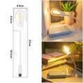 USB rechargeable folding night light with a glowing tungsten filament bulb on a table.