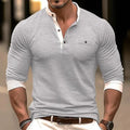 Men's solid colour long sleeve cotton t-shirt on a hanger, showing the round neck design.
