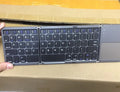 Ultra-thin tri-fold folding touch Bluetooth keyboard in black with touchpad, folded and spread views