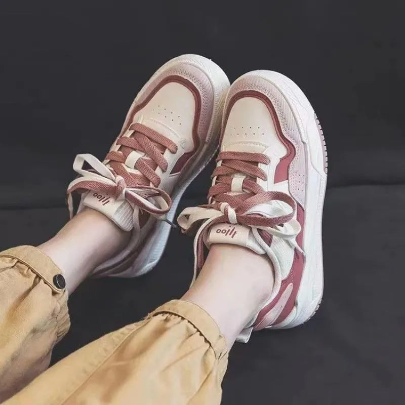 Pink and beige low-top sneakers with rubber soles and height-increasing design