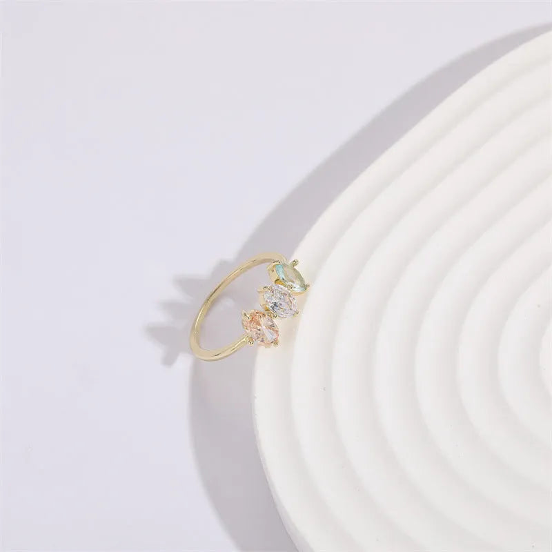 Geometric birthstone ring with horse eye shaped tricolor zircon stones in gold colour
